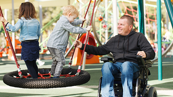 man-in-wheelchair-in-park-with-his-children-top-catheterization-concerns