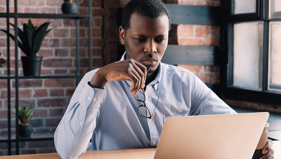 man-looking-at-computer-researching-insurance-coverage-for-intermittent-catheter-supplies