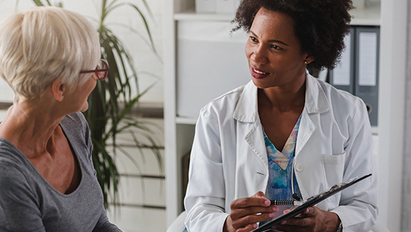 woman-speaking-with-doctor-diagnosing-bladder-disorders