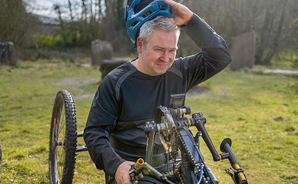 man-on-wheelchair-bike-in-park_600x373