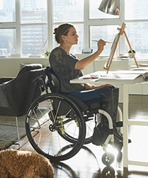woman-in-wheelchair-painting-on-easel-Hollister-Continence-Learning_209x250