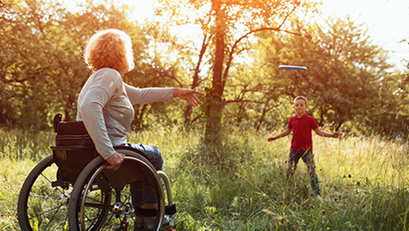 Image-woman-in-wheelchair-playing-frisbee-with-young-son-precautions-wheelchair-users-should-take