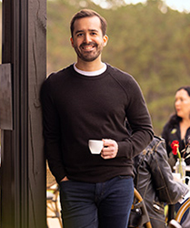 smiling-man-with-cup-of-coffee-outdoor-cafe-hollister-ostomy-quick-educational-tools