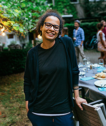 smiling-woman-at-outdoor-dinner-table