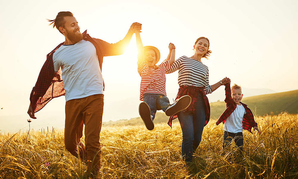 Happy-family-mother-father-children-son-and-daughter-on-sunset