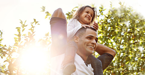 father-giving-piggyback-ride-to-daughter-preventing-skin-problems-around-a-stoma-480x250