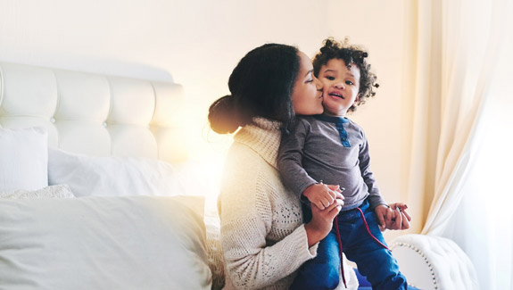 mother-bonding-with-baby-boy-at-home-taking-care-of-skin-around-a-stoma-575x325