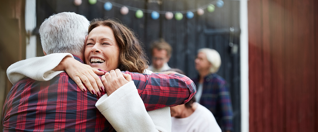 woman-hugging-man-at-outdoor-party-welcome-to-hollister-incorporated